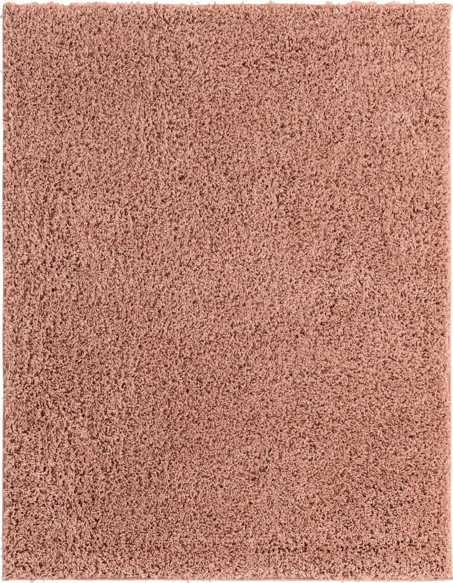 A soft, plush 5'x5' square pink shag rug with a textured pile, perfect for adding warmth to any indoor space.