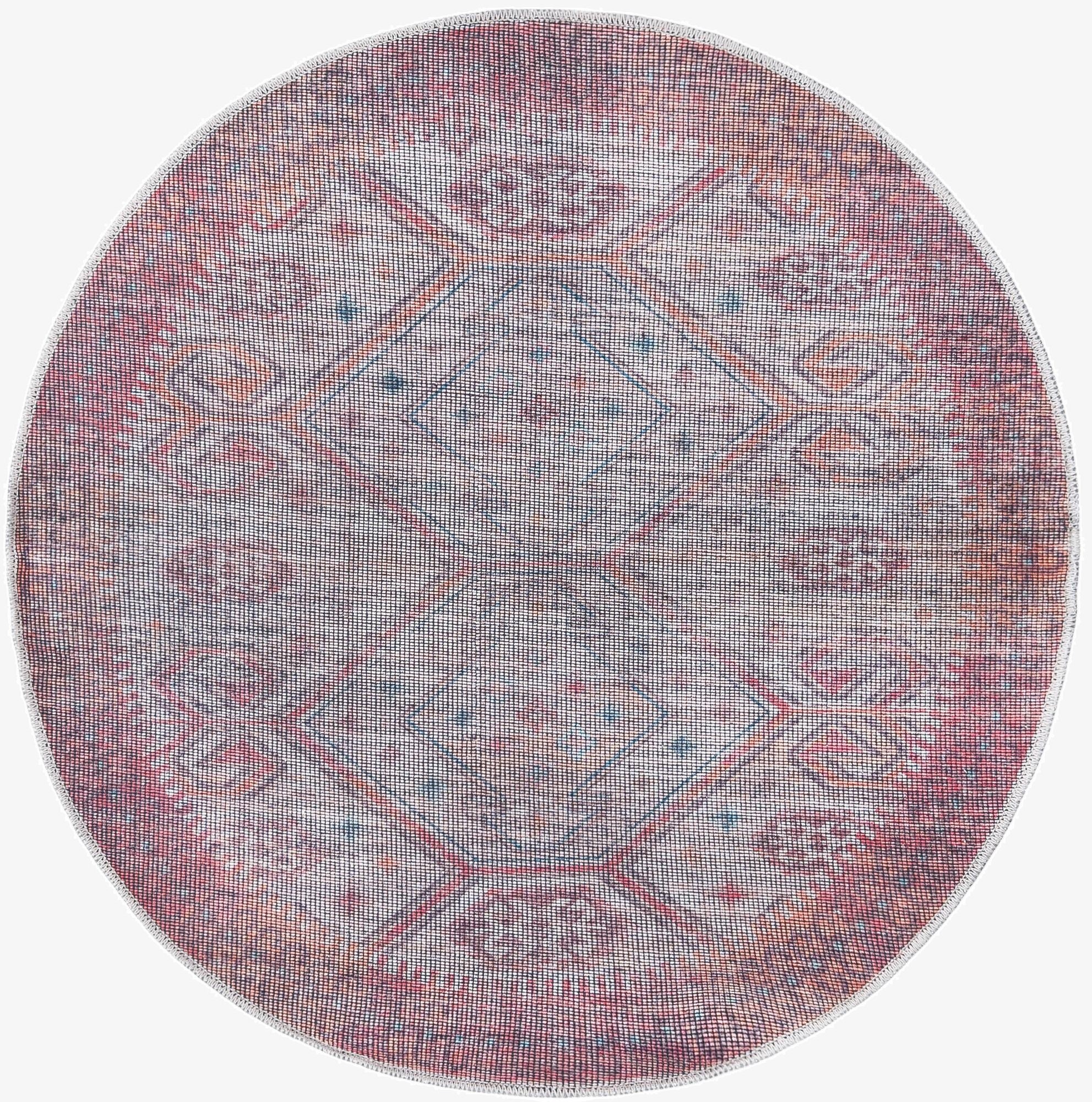 A 4' round Sisu rug in rust red and beige, featuring a faded Southwestern tribal pattern with geometric shapes, on a white background.