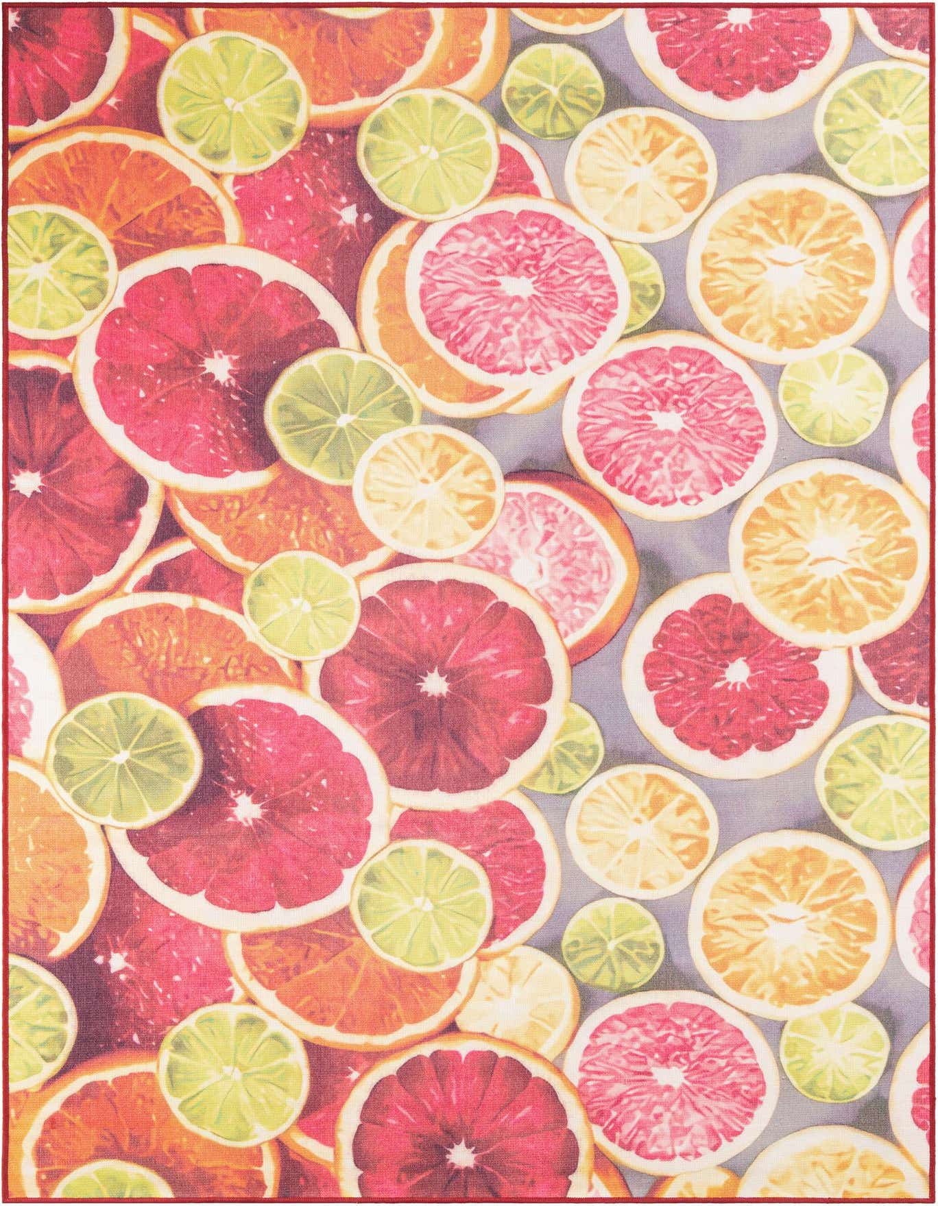 A rectangular 6x9 rug featuring a vibrant, modern pattern of various citrus fruit slices in rust red, pink, orange, and lime green on a light grey background.