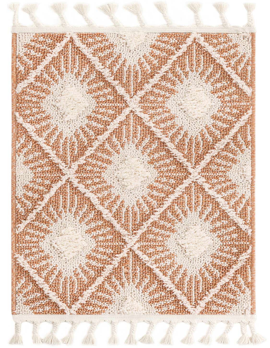 A 2x3 rectangular indoor rug featuring a bohemian trellis pattern in terracotta orange and cream, with braided tassels.