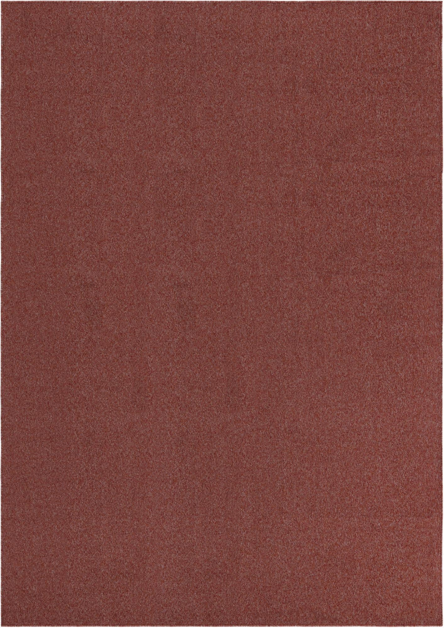 A 7x10 rectangular Everyday Solid rug from Rugs.com, featuring a thin pile and a mottled orange-red color.