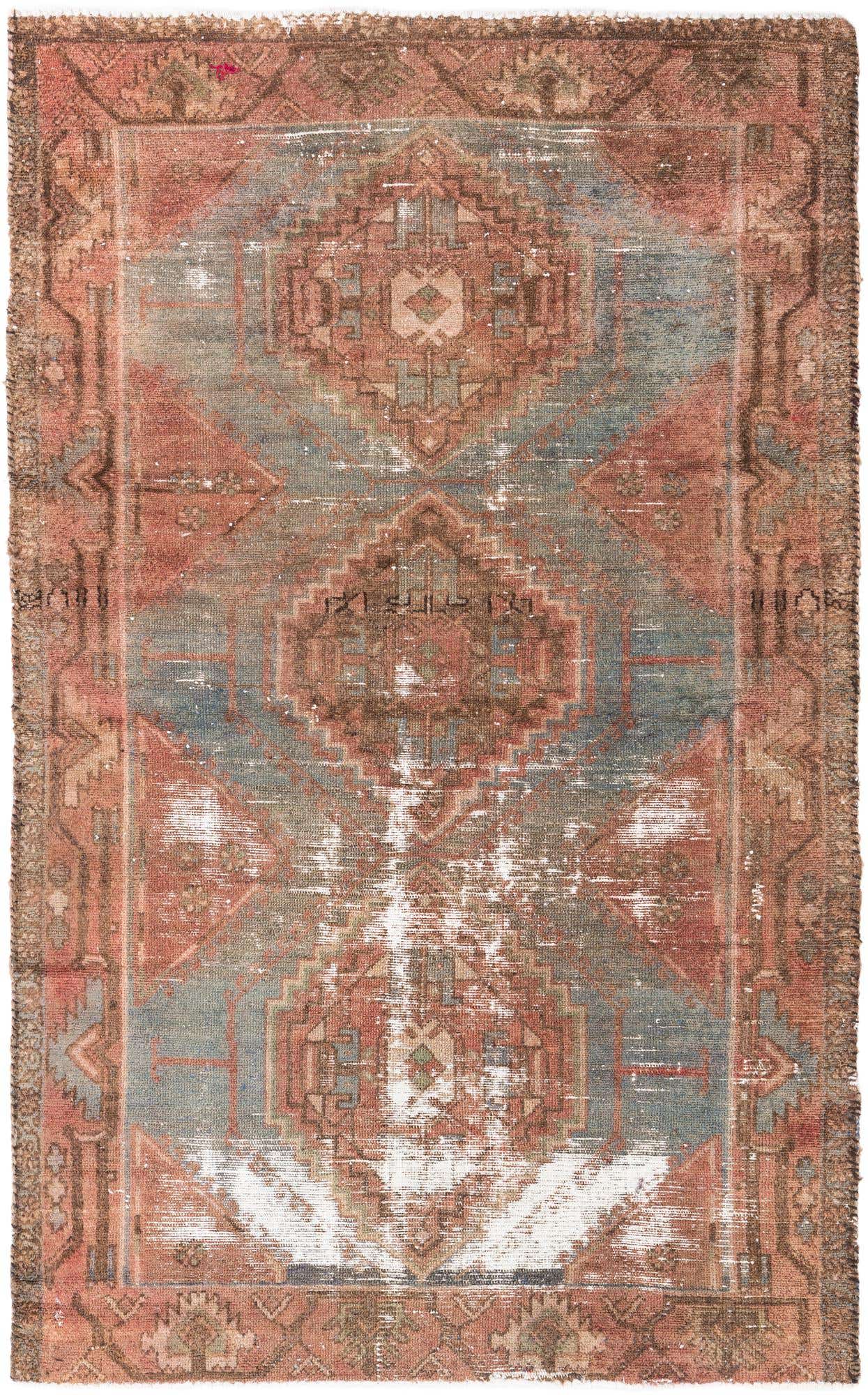A distressed 4x6 rectangular Persian rug with a faded medallion pattern in oranges, reds, and muted blues, showcasing a vintage, worn look.