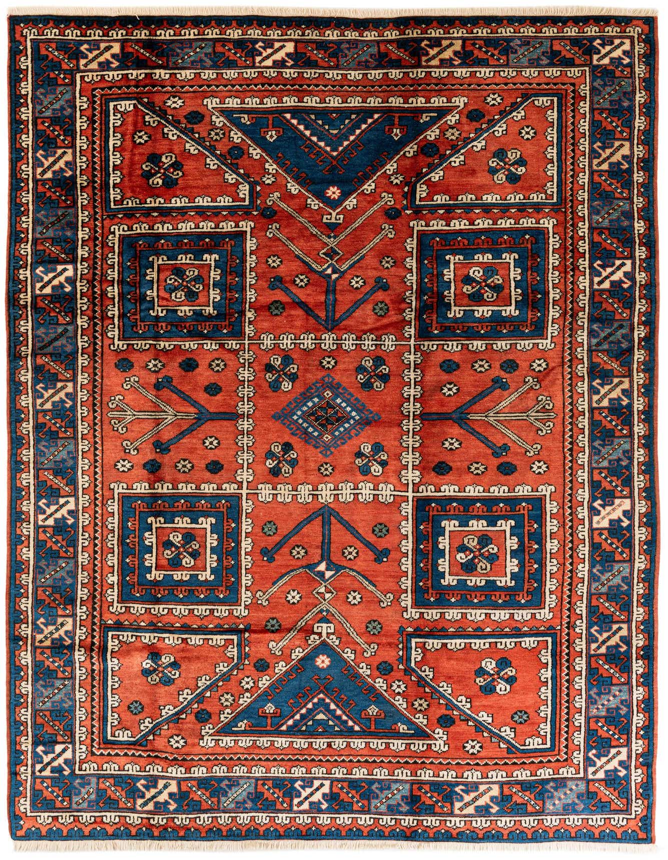 A 7x10 rectangular Yalameh rug with a traditional tribal pattern in deep oranges, reds, and navy blue, featuring geometric motifs.