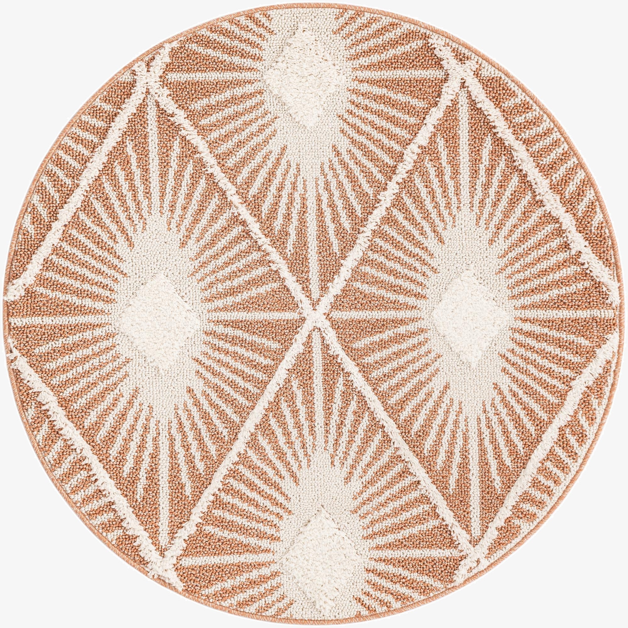 A round 4' orange and white textured rug with a geometric sunburst pattern, perfect for a patio.