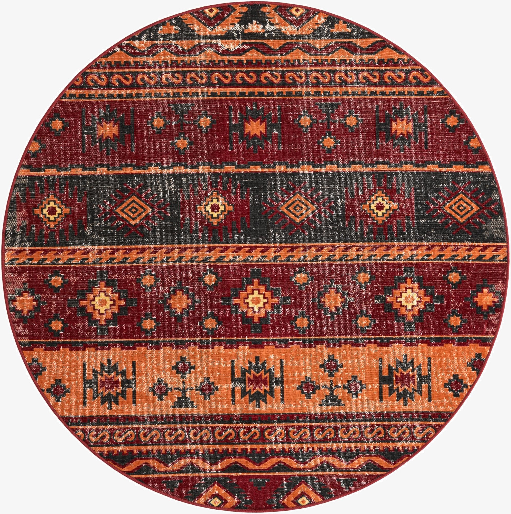 A 6' 1 x 6' 1 round rug in oranges and reds, featuring a distressed Southwestern or tribal pattern with geometric bands.