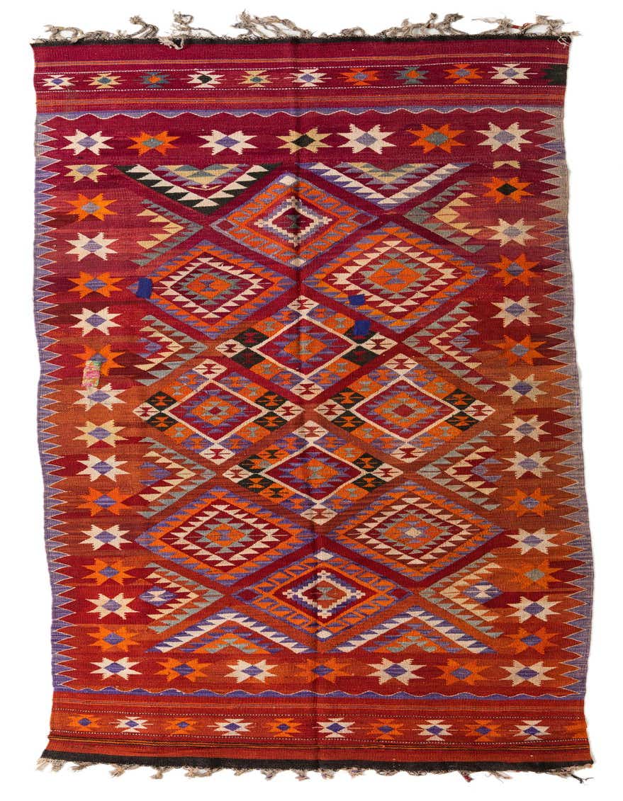 A 14 ft runner rug from the Kilim Fars collection, featuring vibrant oranges and reds in a tribal, geometric pattern.