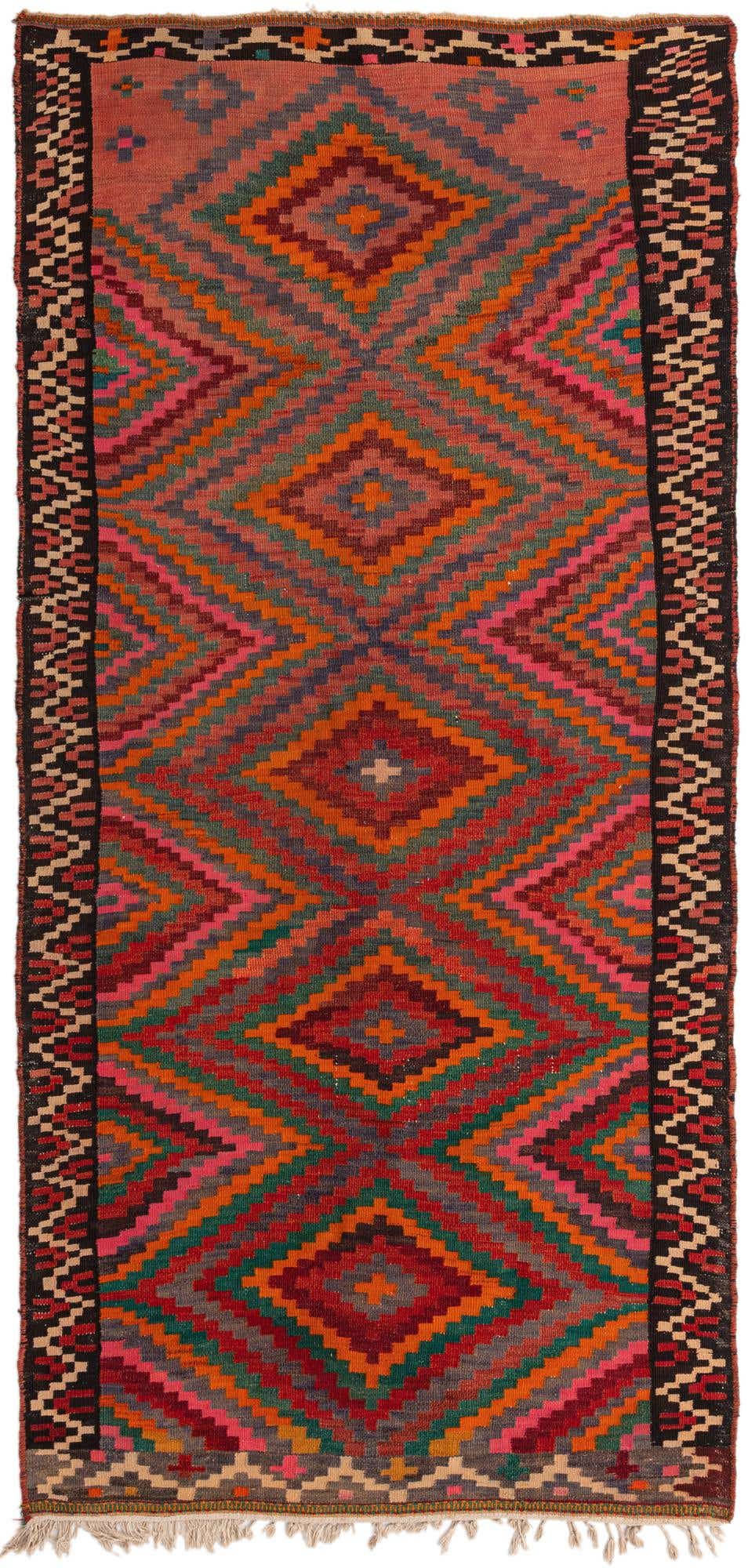A 10 Ft Kilim Fars runner rug with a vibrant tribal diamond pattern in oranges, reds, pinks, and greens, perfect for a hallway.