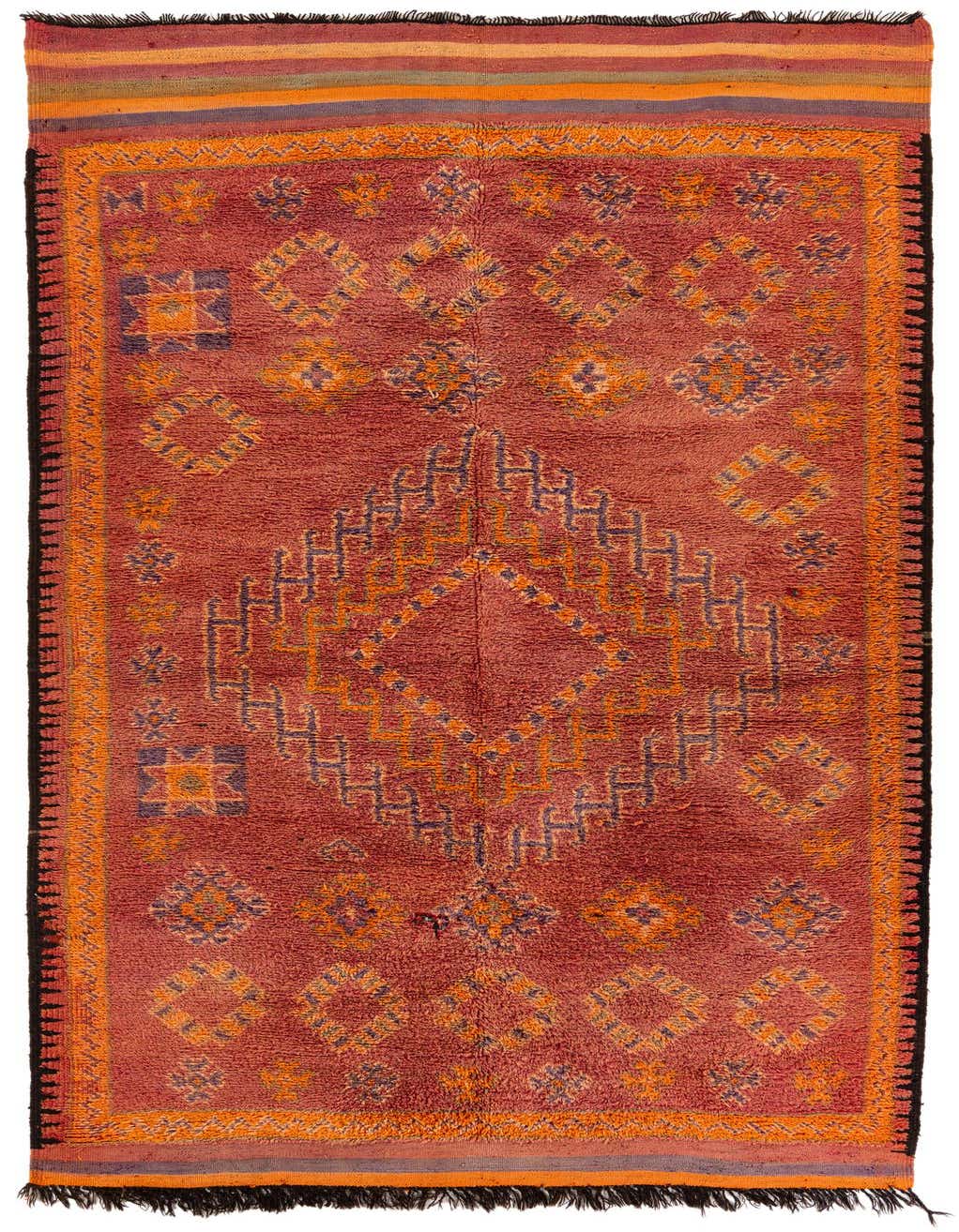 A 13 ft runner rug in oranges and reds, featuring a Southwestern tribal medallion pattern, ideal for a hallway.