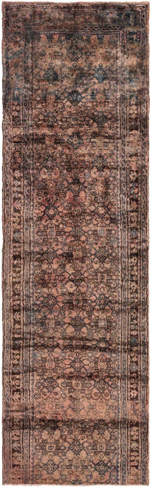 A 12 ft runner rug with a distressed Persian pattern in shades of orange, red, and dark blue, ideal for a hallway.
