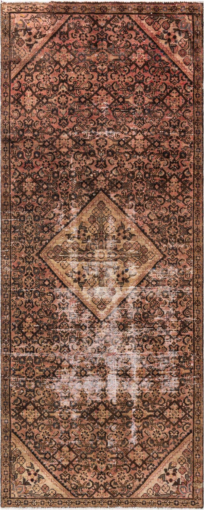 A 10 ft runner rug with a faded Persian medallion pattern in shades of orange, red, and brown, ideal for a hallway.