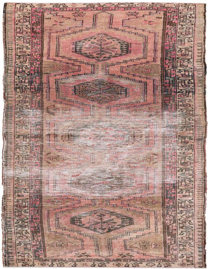 A 10 ft runner rug in a vintage Persian style, featuring faded oranges and reds with a central medallion and geometric patterns.
