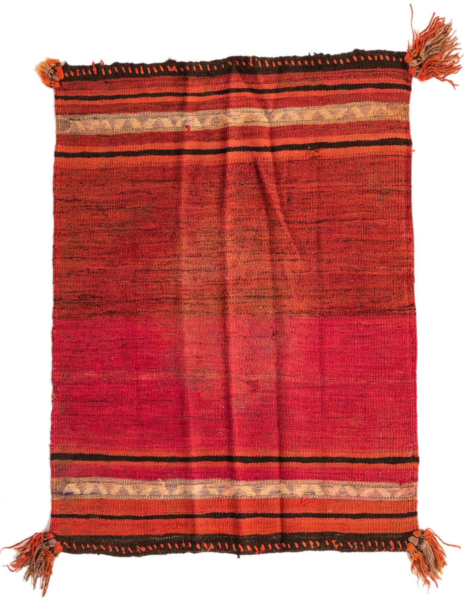 A square Kilim Fars rug in vibrant oranges and reds with black and cream stripe accents and corner tassels.