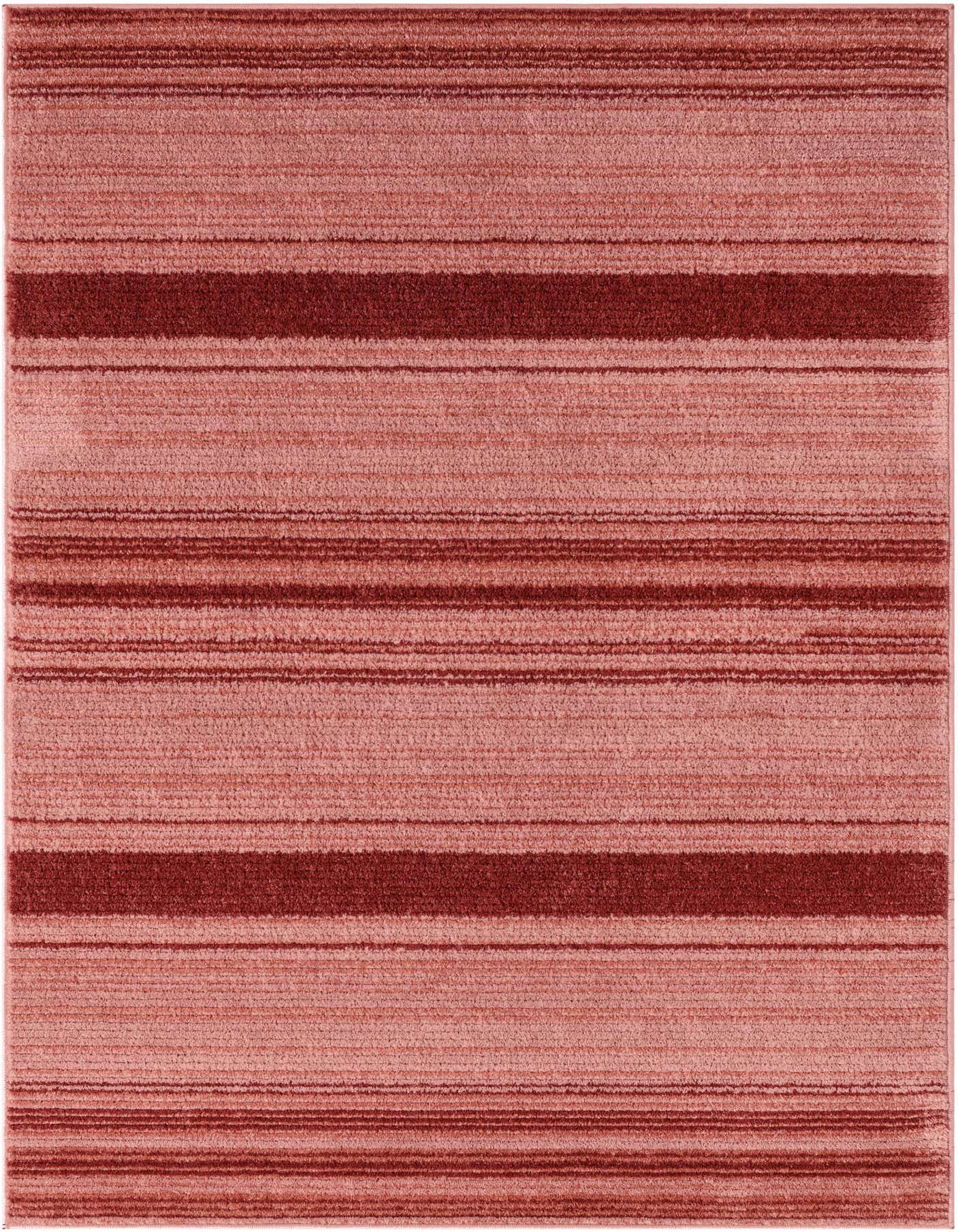 A 4x6 rectangular indoor area rug with varying shades of pink and red horizontal stripes, featuring a textured, high pile.