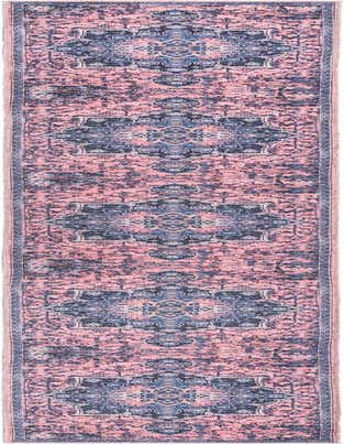 A 13 ft runner rug in a distressed vintage medallion pattern with shades of pink, orange, and navy blue.