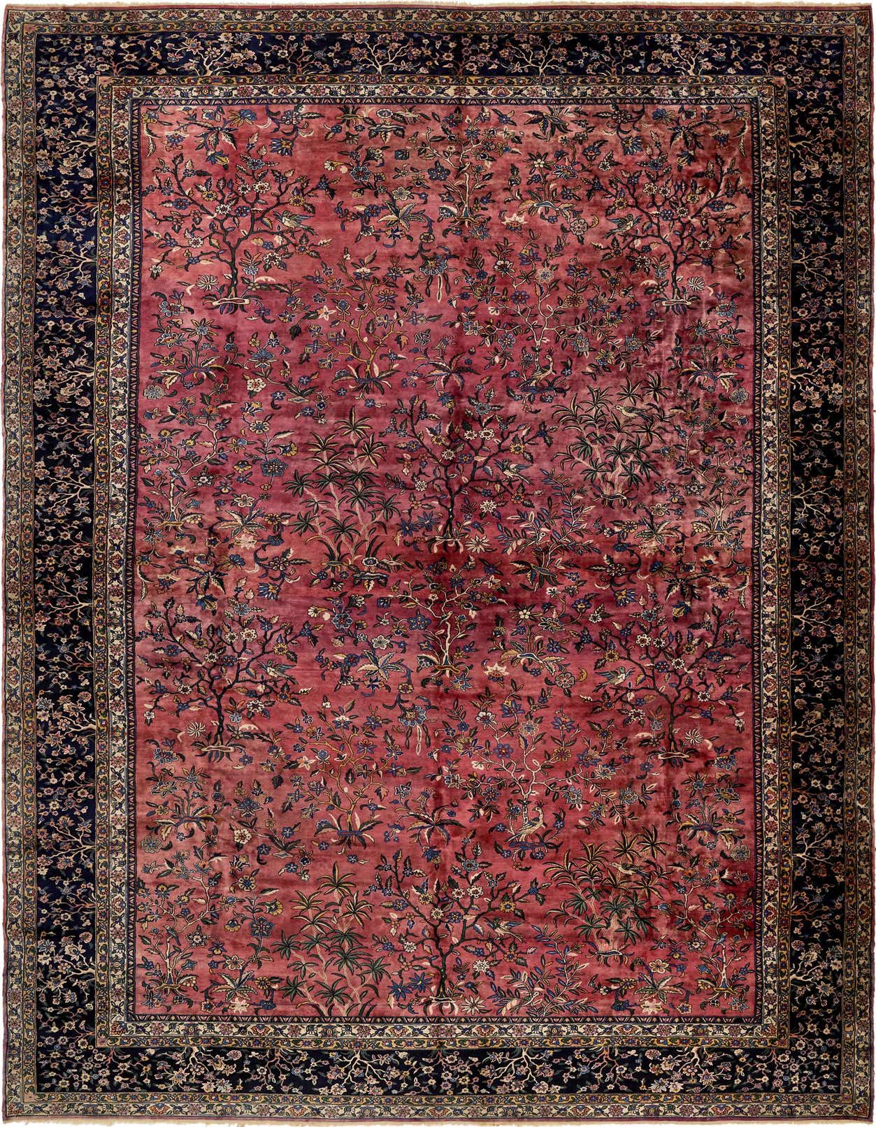A large 13x18 rectangular Sarough rug featuring a detailed botanical and floral pattern in oranges and pinks with a dark blue border.
