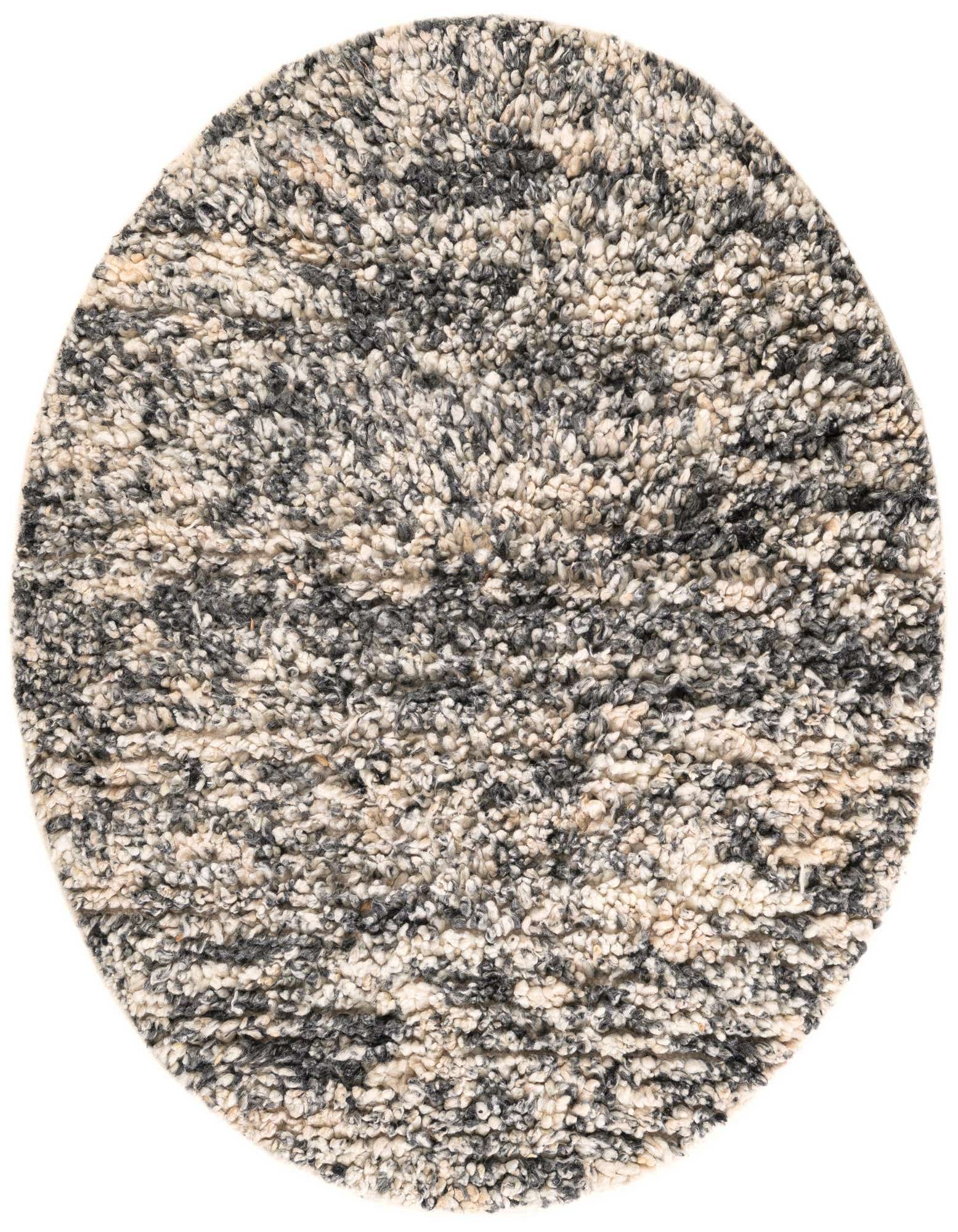 A 4' 1 round Haka Deluxe Shag rug by Rugs.com with a textured pile in mottled black, ivory, and gray.
