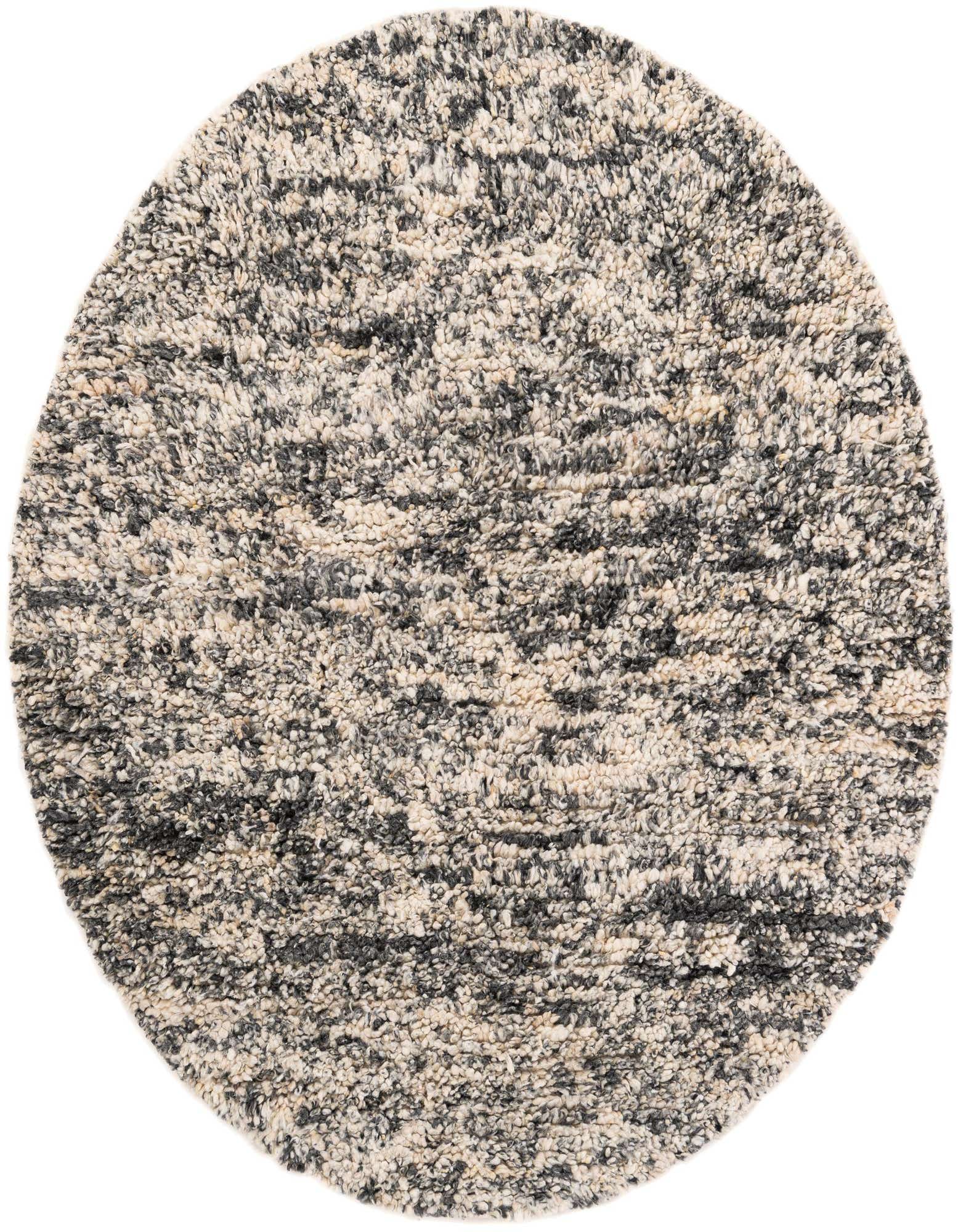 A round, shag area rug with a textured pile, featuring a mottled pattern of black, ivory, and cream fibers.