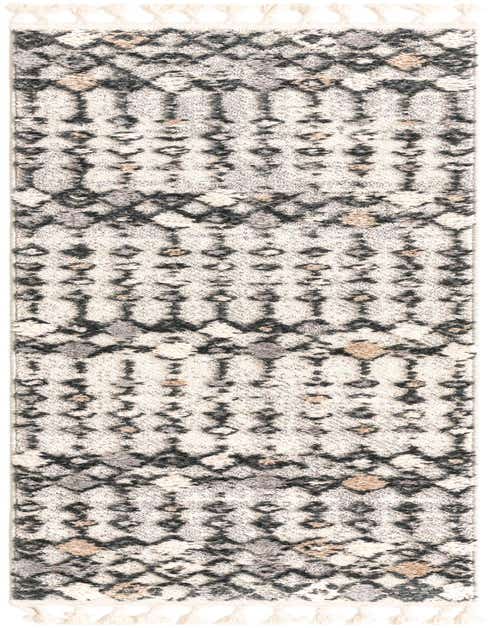 A long 8 ft runner rug with a tribal, modern abstract pattern in textured brown, ivory, and cream tones, featuring tassels.