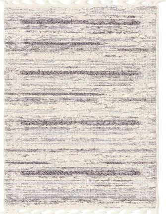 A 12 ft runner rug from the Rugs.com Cherokee collection, featuring an abstract tribal pattern in browns, tans, and ivories with textured pile and tassels.