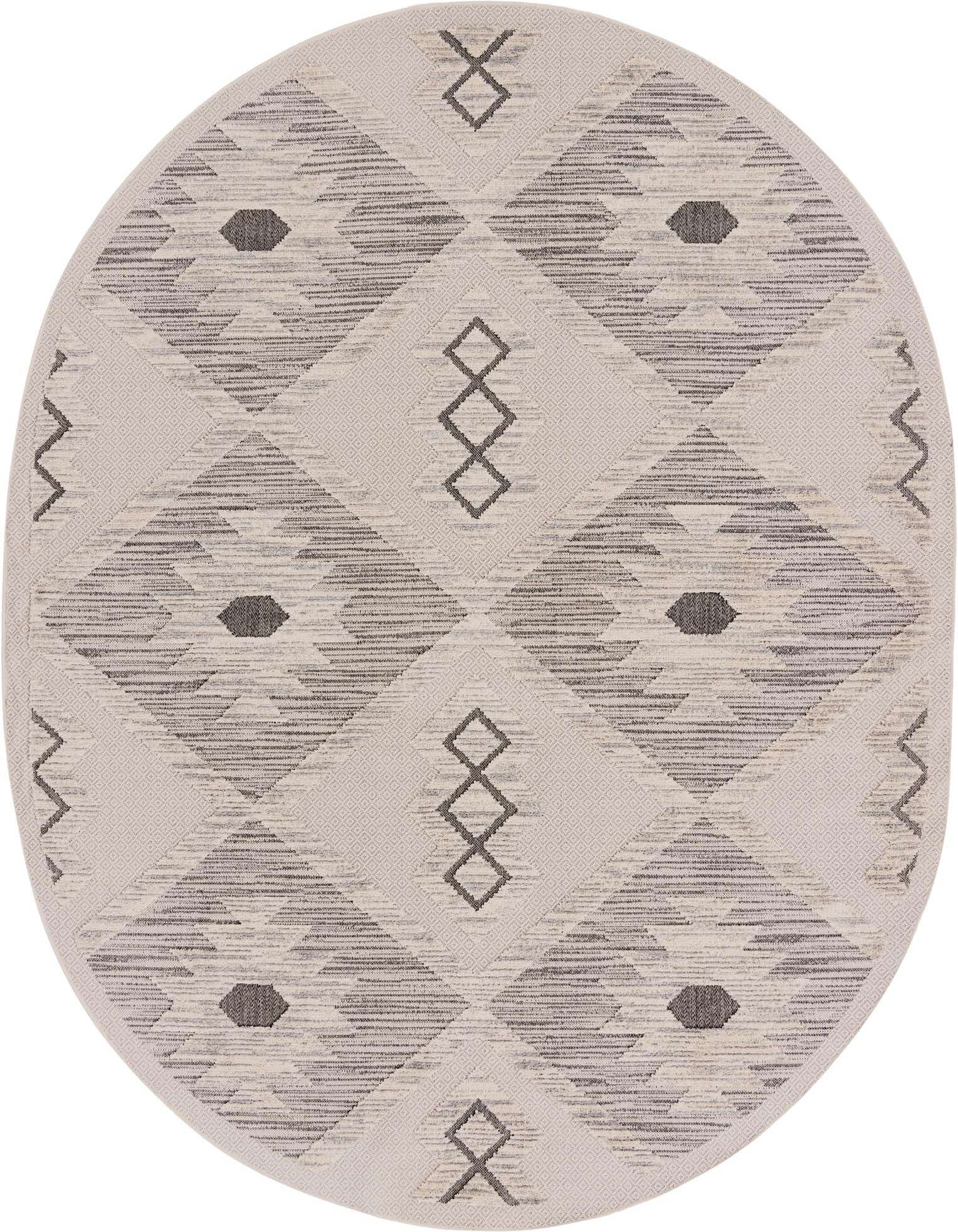 An oval ivory and cream rug with a modern Southwestern pattern of geometric shapes and tribal motifs, featuring a textured high/low pile.