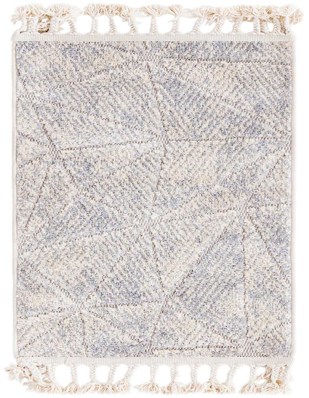 A 2x3 rectangular ivory and cream rug with a subtle modern geometric pattern and decorative braided tassels on both ends.