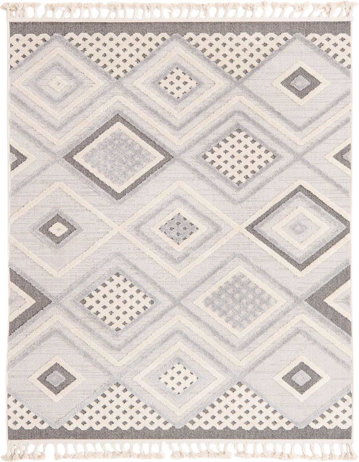 A 5x8 rectangular Arlo rug featuring a modern abstract diamond pattern in shades of ivory, cream, and light gray, with a high/low textured pile and decorative tassels.