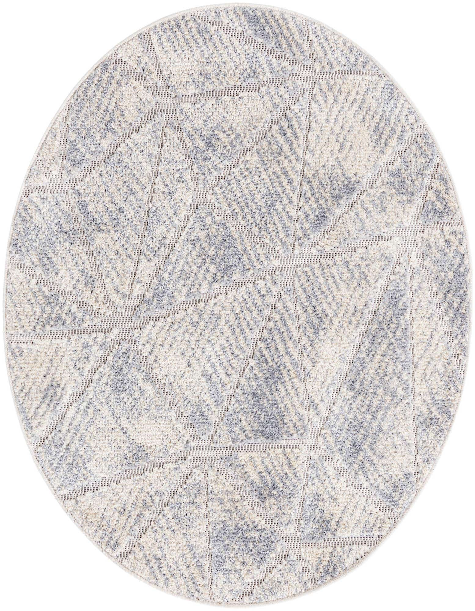 A round ivory and cream rug with a modern geometric pattern in varying pile heights, suitable for an indoor living space.