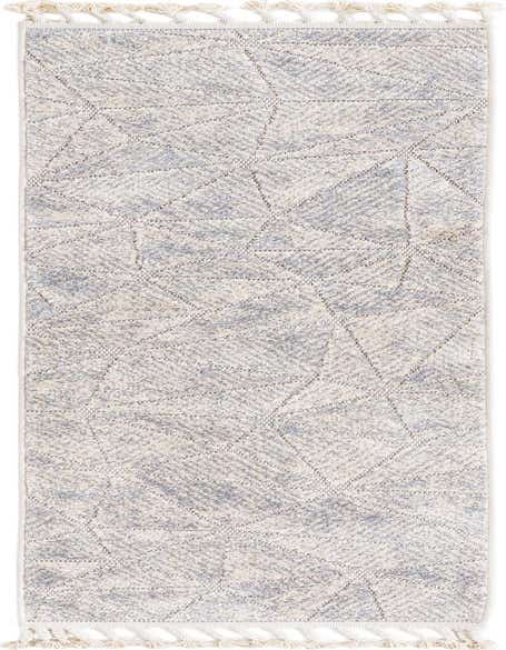 An 8 ft runner rug in ivory and cream with a textured high/low pile and subtle modern geometric pattern, featuring decorative tassels.