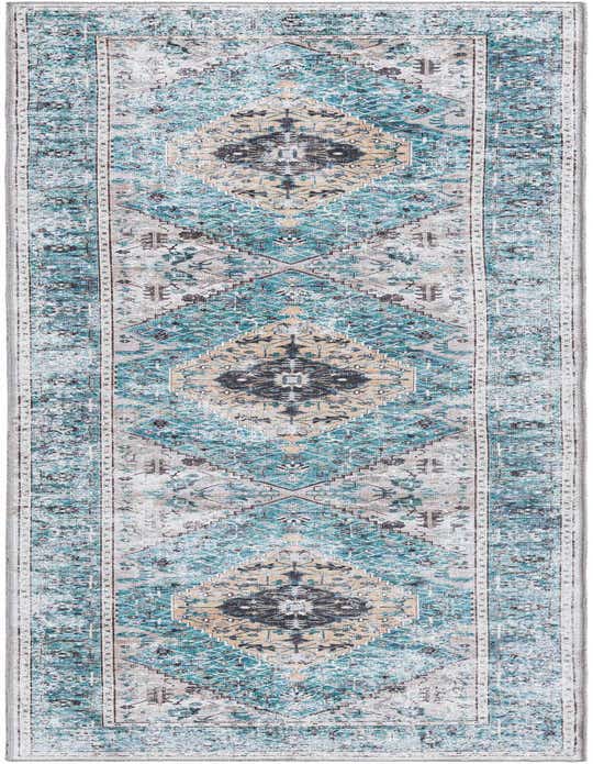 A 10 ft runner rug from the Yara Collection with a distressed tribal medallion pattern in blues, greens, and cream.
