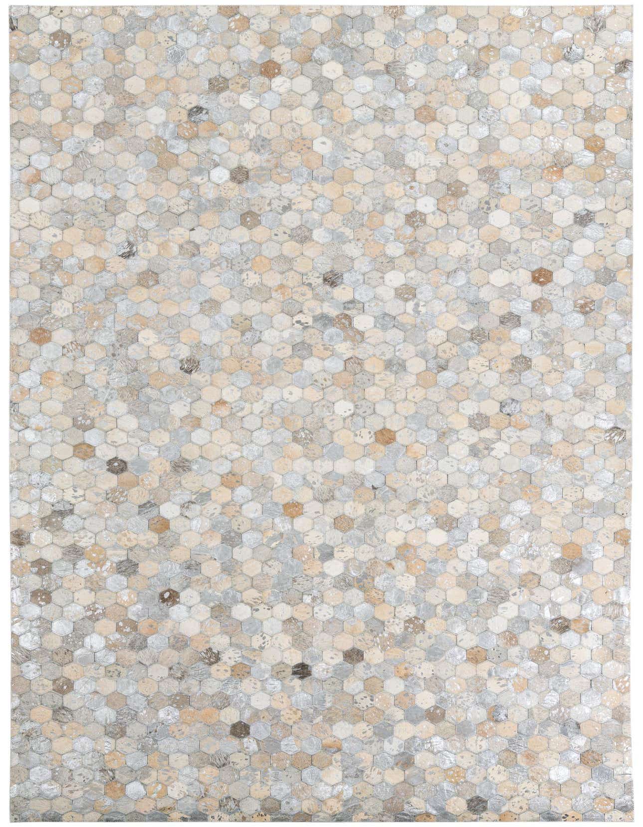 A 5x8 rectangular rug featuring a modern, abstract pattern of small hexagonal cowhide and leather patches in varying shades of gray, silver, and beige.