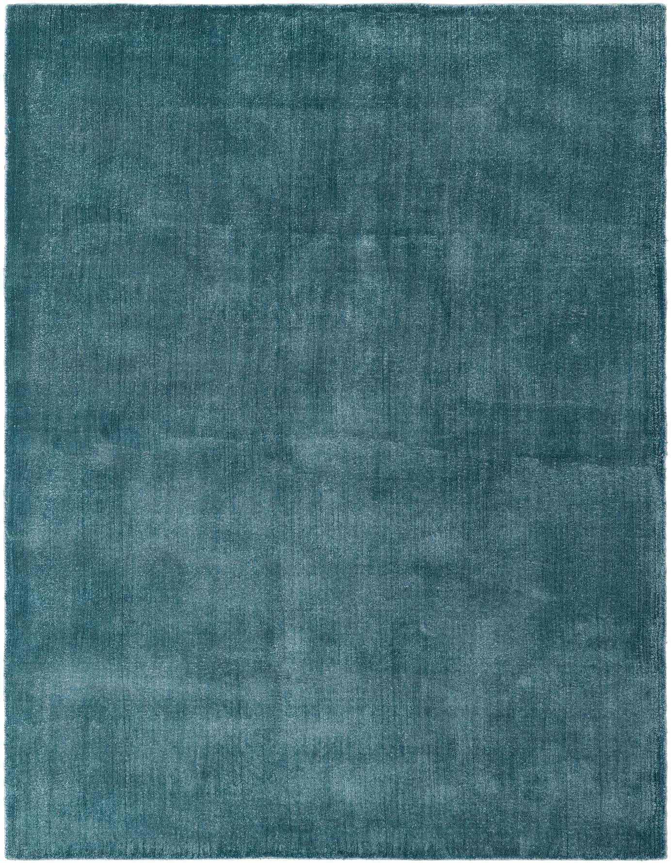 A rectangular 5x8 Luna Collection rug in a solid teal blue color, handmade from wool and cotton, with a high pile.