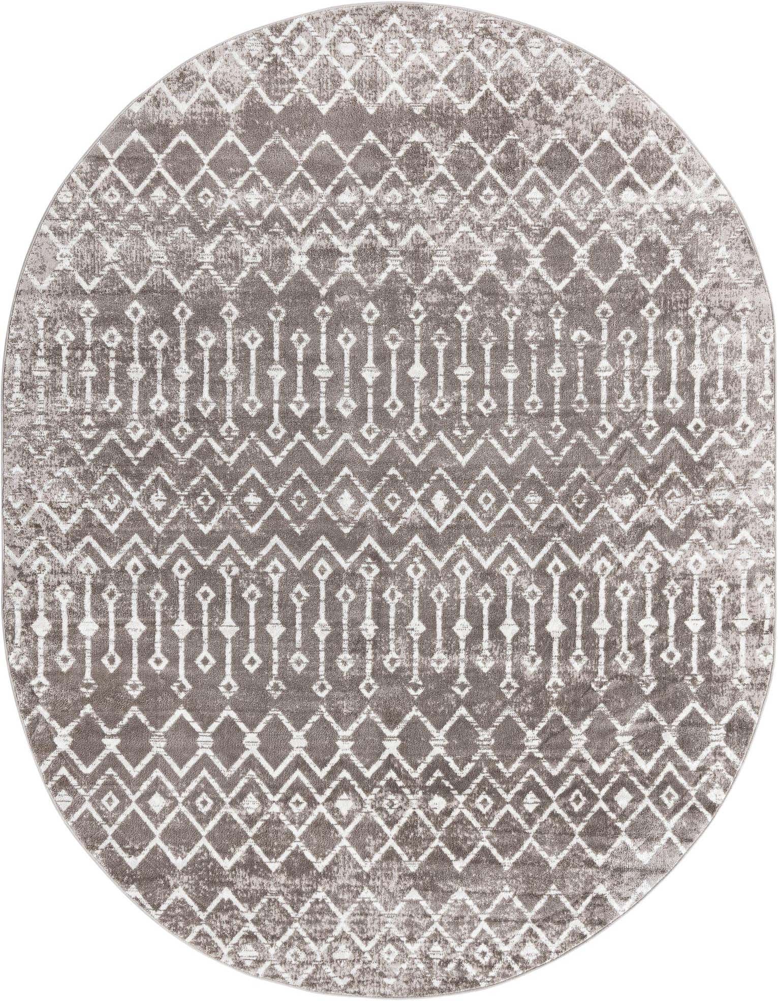 An 8' x 10' oval gray and white Bohemian Trellis rug with a distressed tribal pattern.