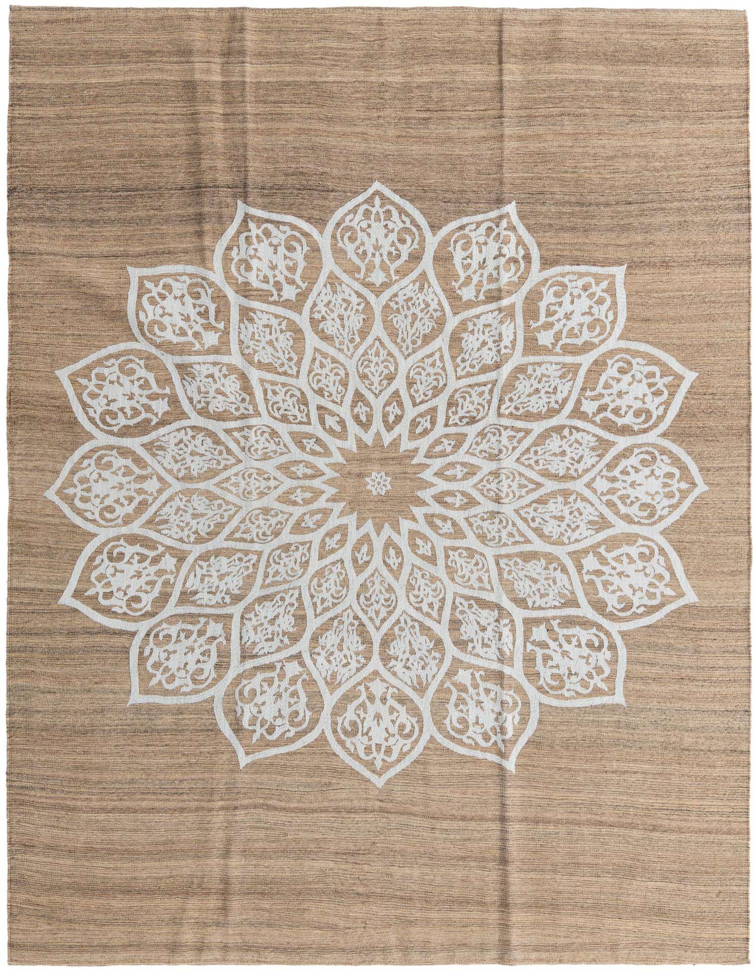 A 7x10 rectangular brown and tan flatweave wool rug with a large white tribal mandala pattern in the center.