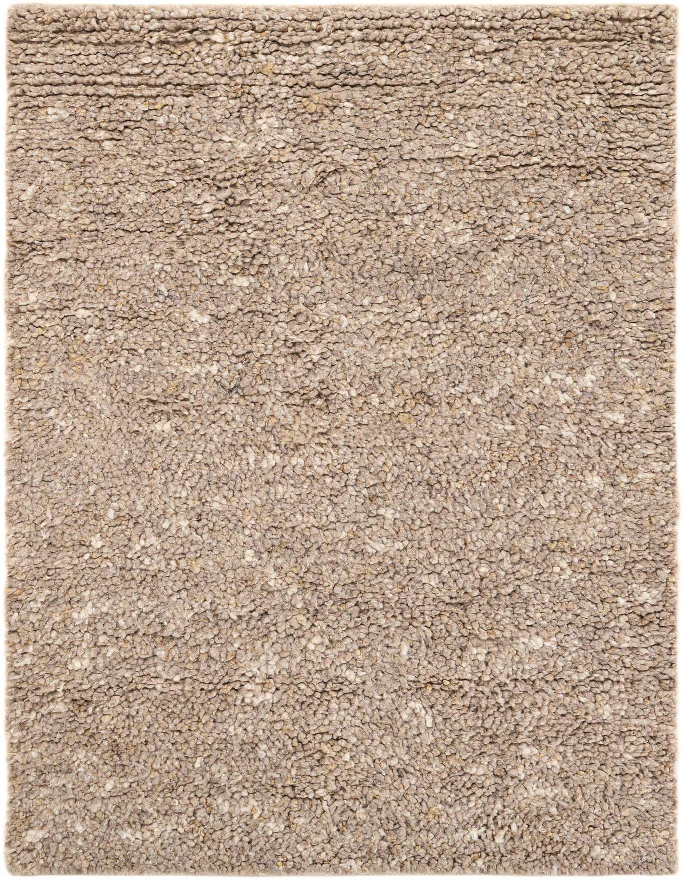 A rectangular 4x6 Haka Deluxe Shag rug in varying shades of brown, tan, and cream, showcasing its thick, textured New Zealand wool pile.