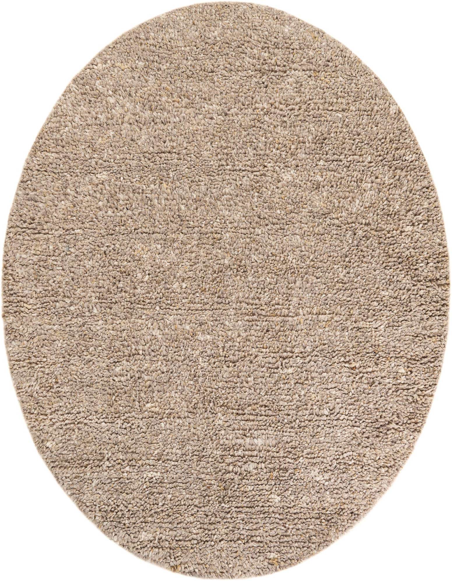 A 7' 10" round Haka Deluxe Shag rug in a blend of brown, tan, and cream New Zealand wool, featuring a textured, solid modern design.