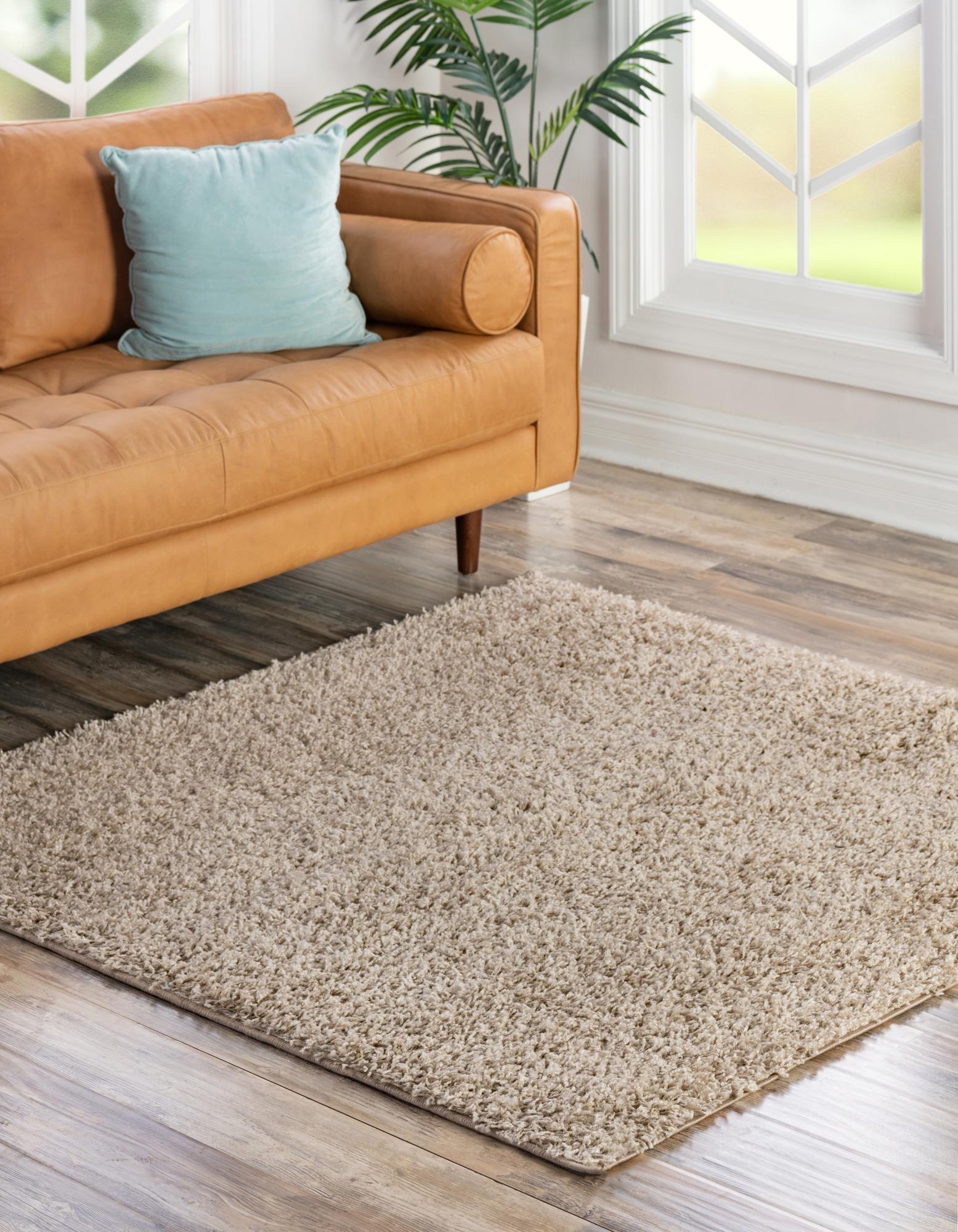 A soft, plush 7' 10 x 7' 10 square shag rug in a warm, solid tan color, perfect for a cozy living space.
