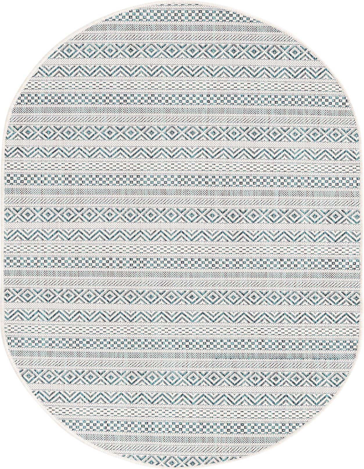 An oval 3' 0 x 5' 3 indoor/outdoor rug with a modern tribal pattern in shades of blue and green on a light background, suitable for a patio.