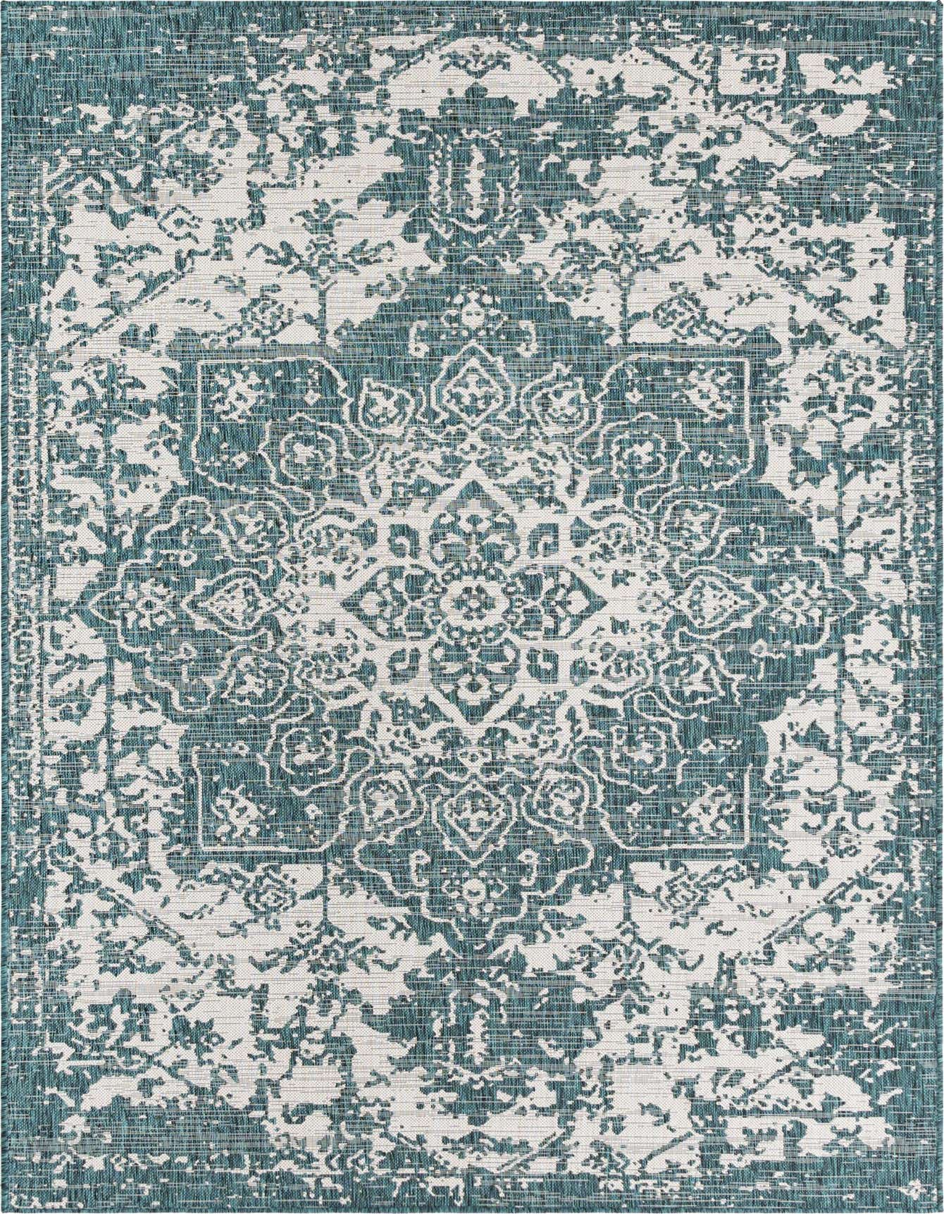 A 6x9 rectangular Jill Zarin Outdoor rug featuring a distressed Mediterranean medallion pattern in shades of blue and green, suitable for indoor or outdoor spaces.