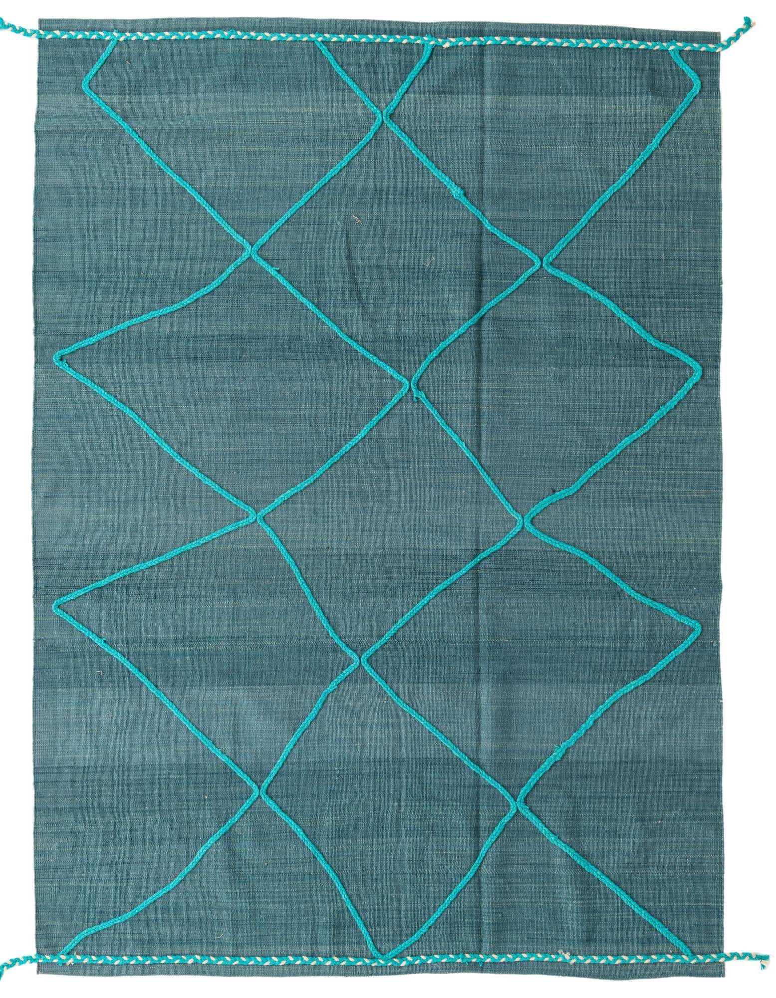 A 5x8 rectangular blue wool shag rug with a bold turquoise diamond tribal pattern, suitable for a living room.