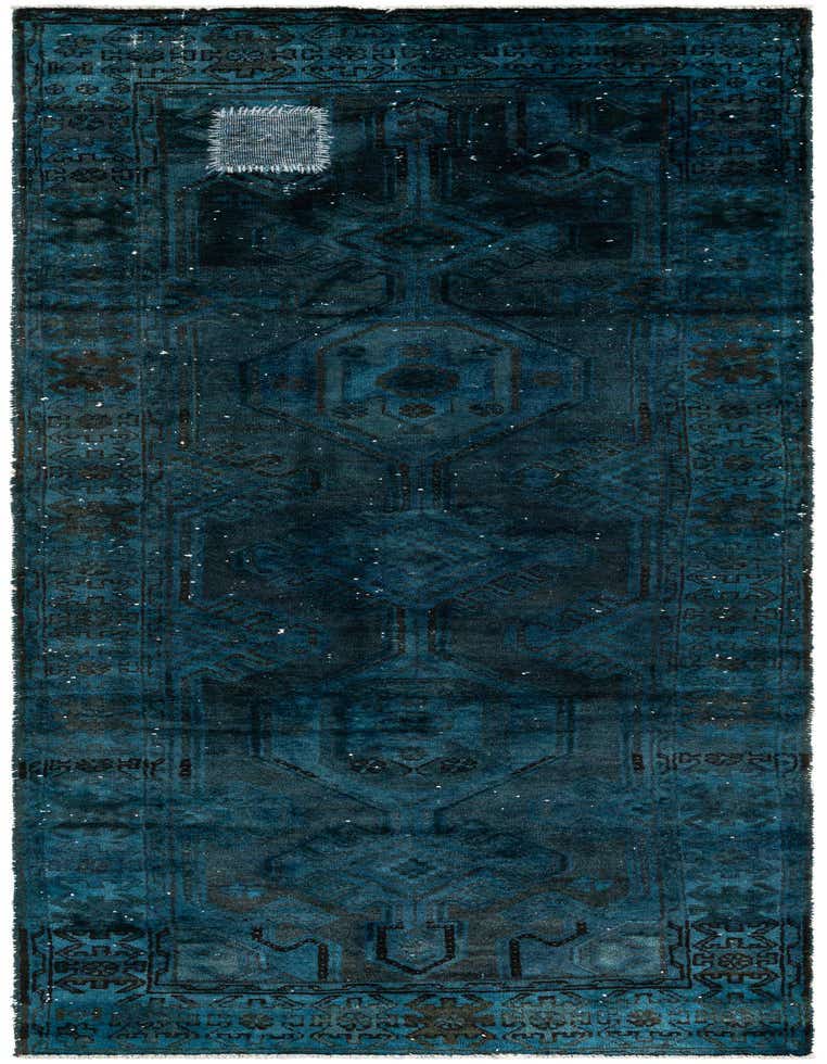 A distressed 9 ft runner rug in deep blues and greens, featuring a faded Persian medallion pattern with a visible patch.
