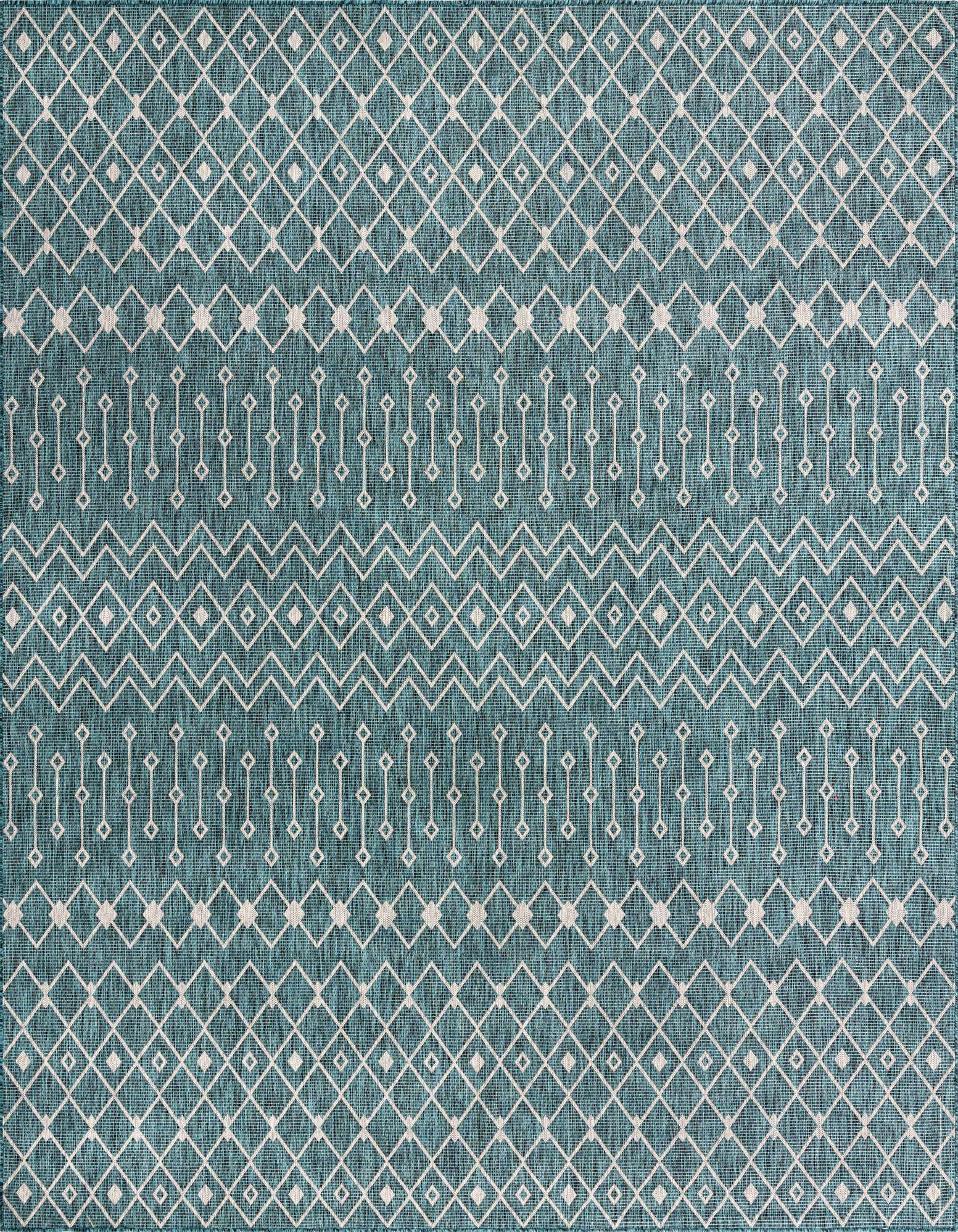 A close-up of a square 13' x 13' Rugs.com Outdoor Lattice rug, featuring a teal background with white tribal and modern geometric patterns, suitable for indoor/outdoor use.