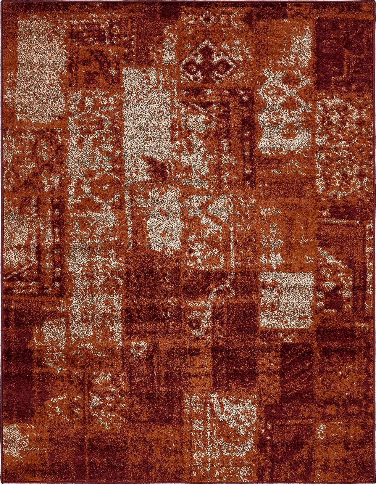 A 5x8 rectangular indoor rug with a Southwestern, rustic, and abstract patchwork pattern in shades of orange and red.
