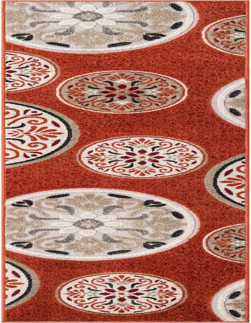 An 8 ft runner rug in a vibrant orange with a modern botanical pattern of cream, red, and black medallions, suitable for a hallway or patio.