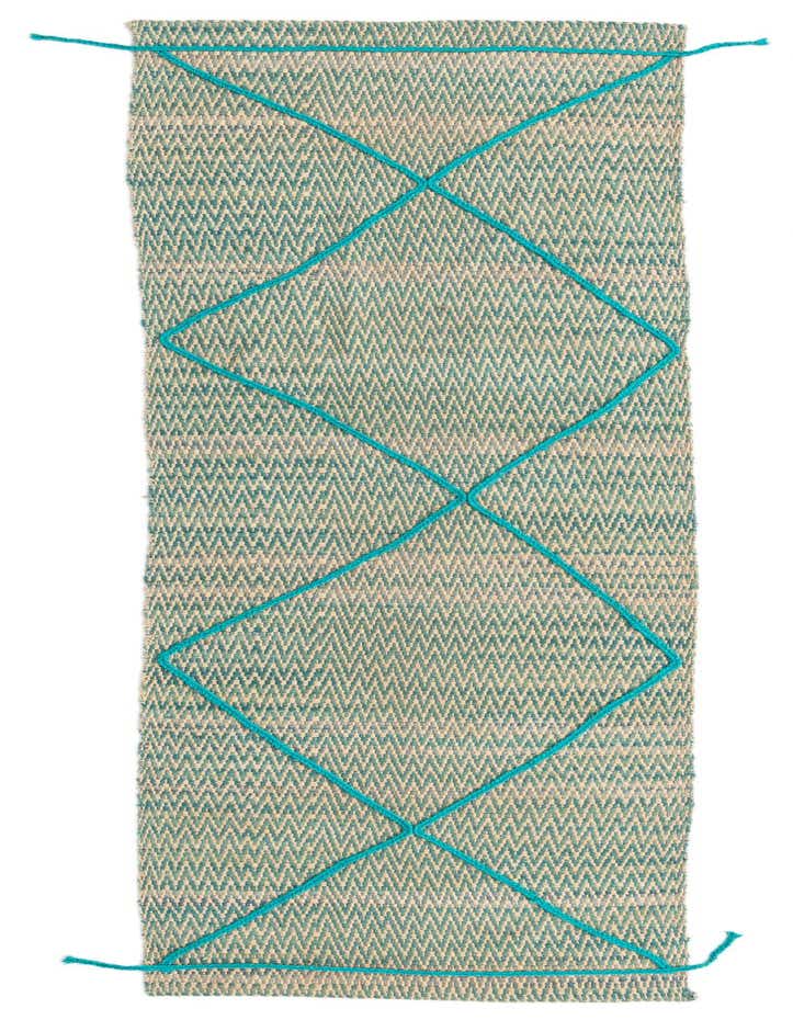 A 10 ft Darya runner rug in blues and ivories with a modern oriental pattern and textured wool.