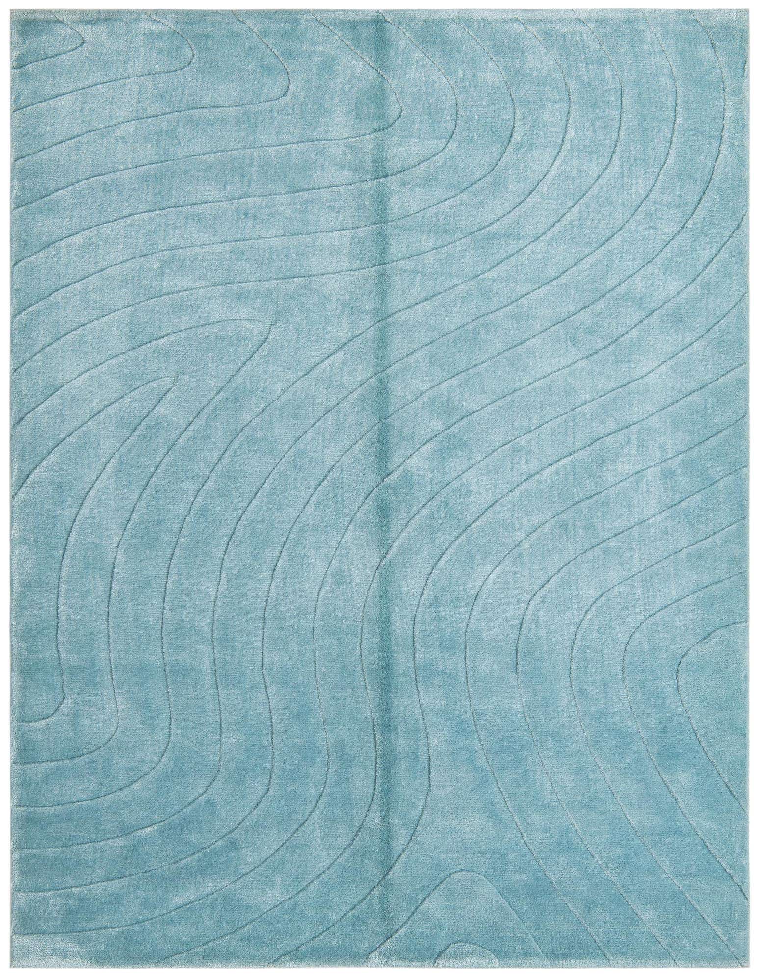 A 4x6 rectangular blue wool rug with a high pile and a modern, flowing wave pattern.
