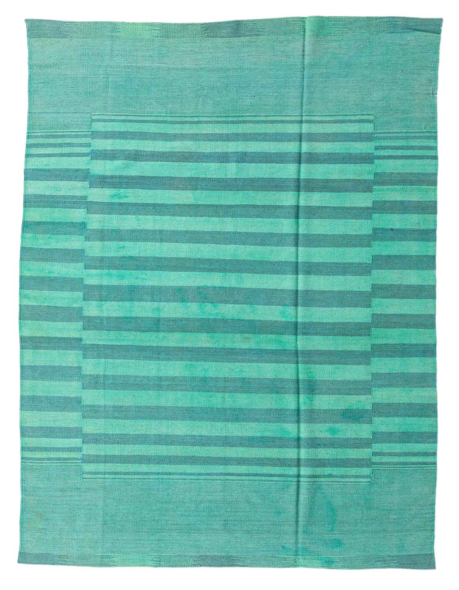 A 5x8 rectangular blue flatweave wool rug featuring a modern tribal stripe pattern in varying shades of blue.