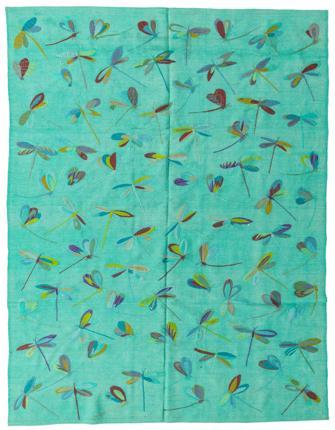 A 6x9 rectangular blue flatweave rug with a playful pattern of colorful dragonflies in various hues.
