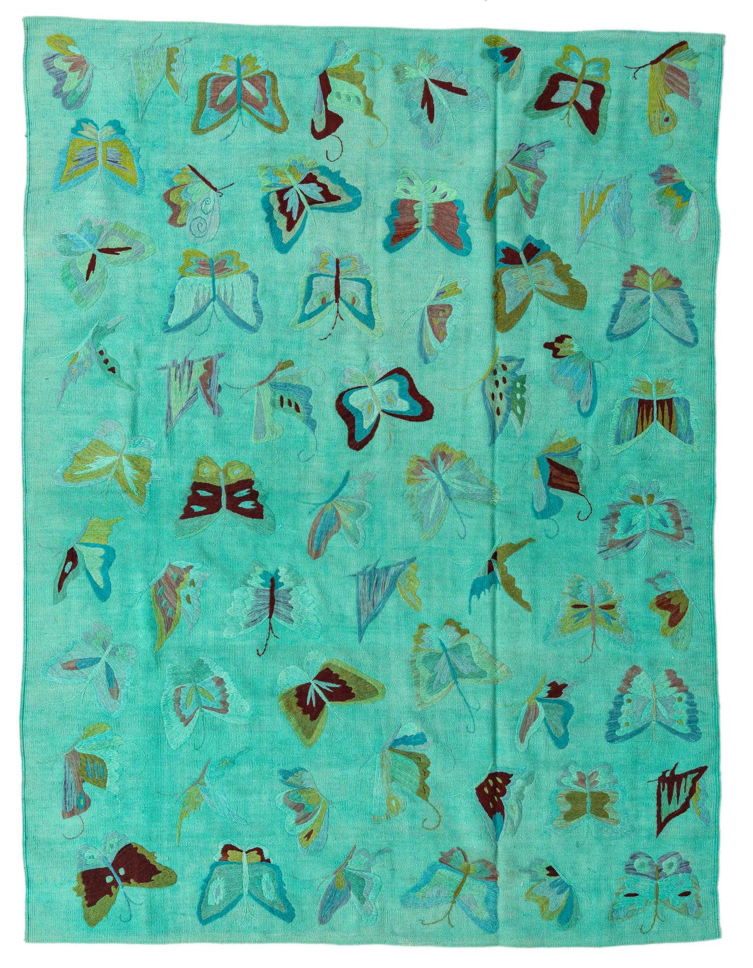 A 5x8 rectangular blue flatweave rug with a vibrant, multicolored butterfly pattern, suitable for a living room.