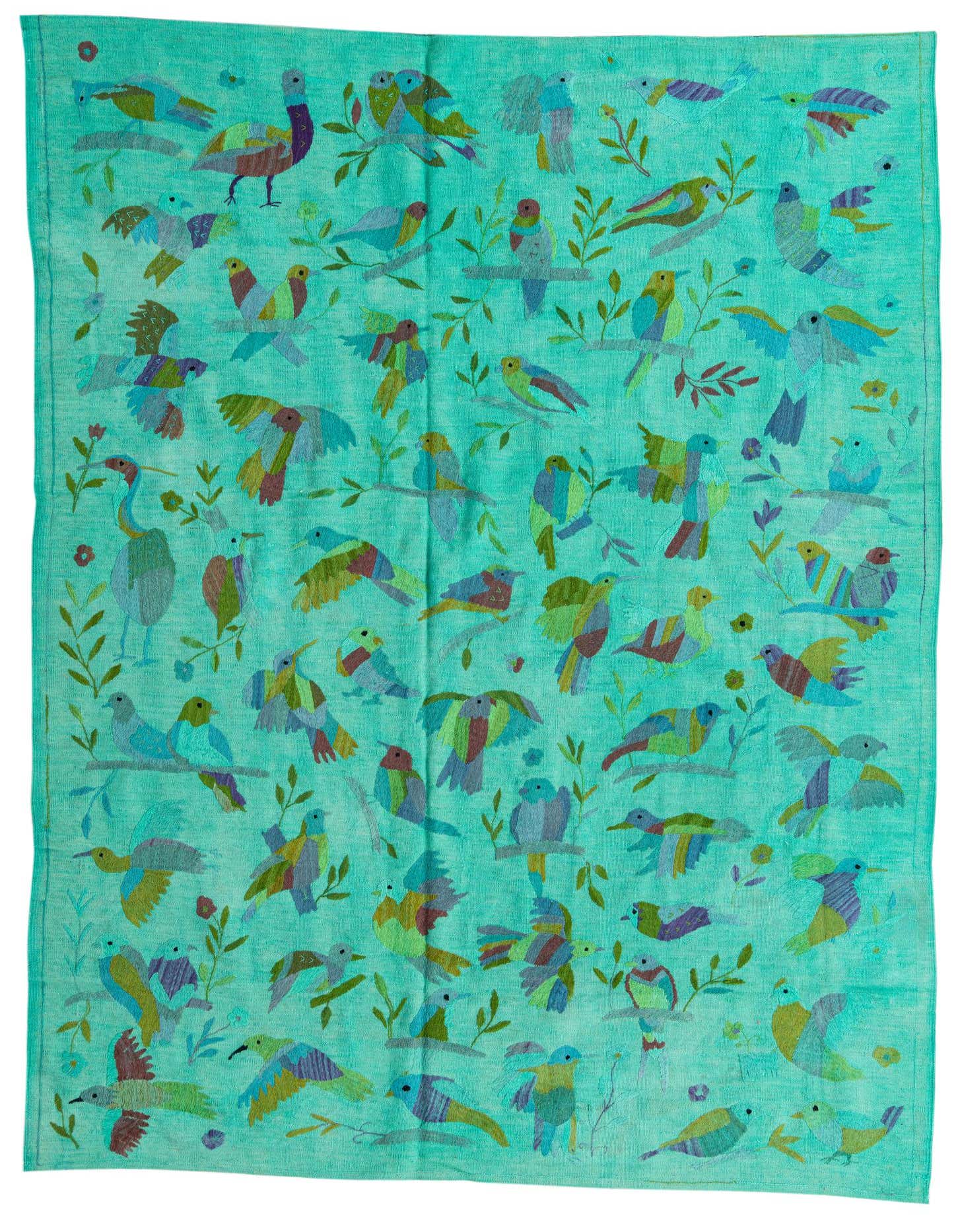 A 6x9 rectangular flatweave rug featuring a vibrant, multicolored bird and leaf pattern on a teal background.
