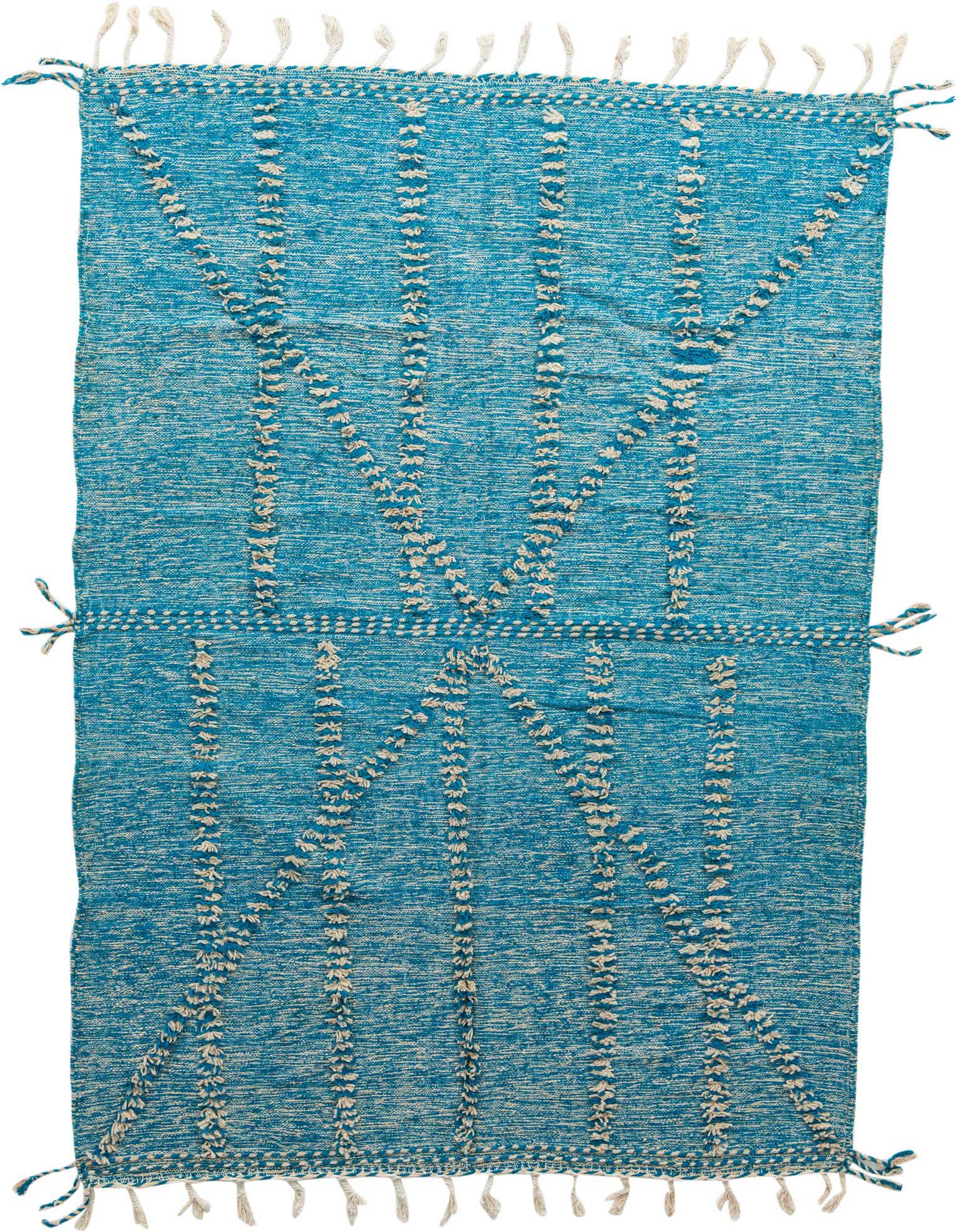 A 7x10 rectangular blue shag rug with a cream tribal pattern and decorative tassels on a white background.